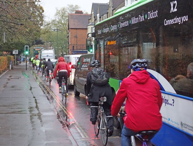 line-of-cyclists-iffley-road-wet